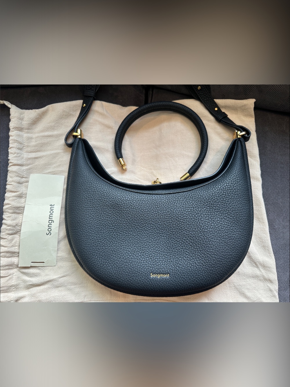 Songmont Black Pebbled Crescent Shoulder Bag with Gold Hardware